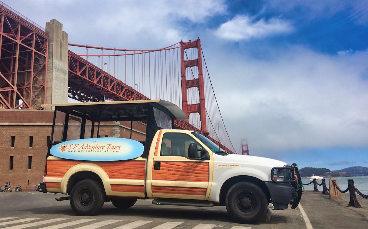 Tour vehicle near Golden Gate Bridge for Beers & Bites Adventure in San Francisco.