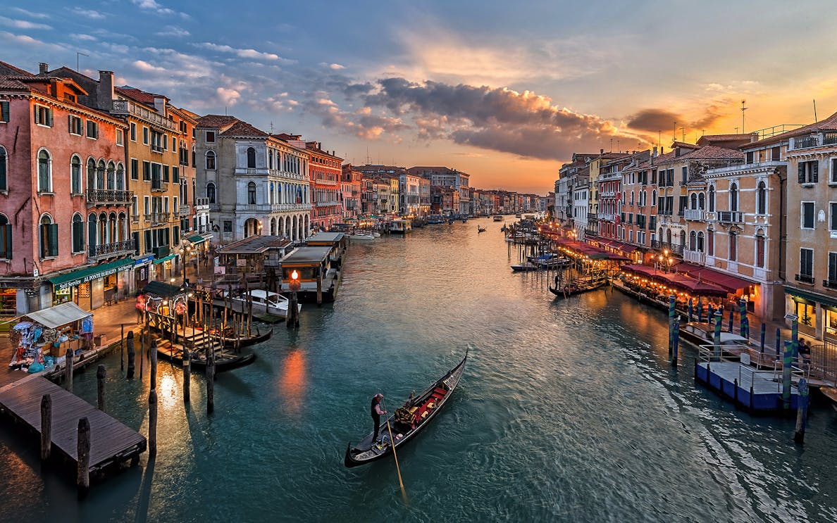 Gondola on the Grand Canal at sunset in Venice, Italy.