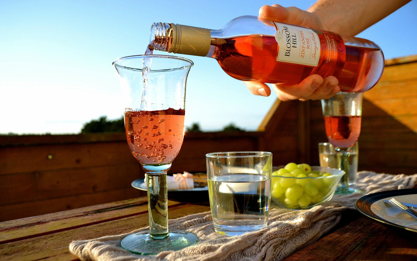 People enjoying a Rosé All Day! wine tasting event on a rooftop in New York City.