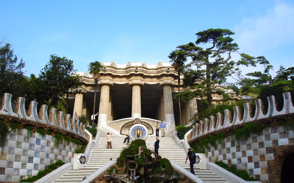 Park Güell entrance with mosaic steps and columns, Barcelona.