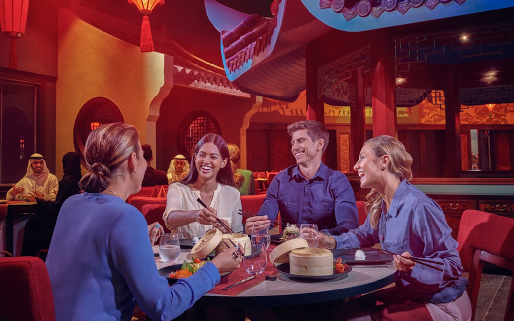 Dining experience at IMG Worlds of Adventure with friends enjoying Asian cuisine.