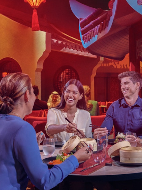 Dining experience at IMG Worlds of Adventure with friends enjoying Asian cuisine.