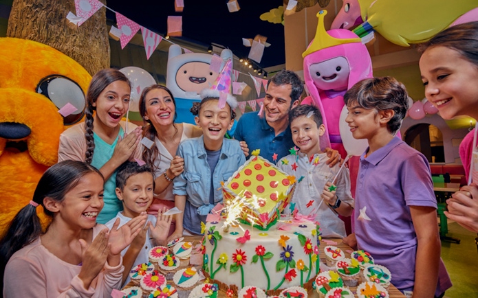 Children celebrating a birthday with themed characters at IMG Worlds of Adventure.