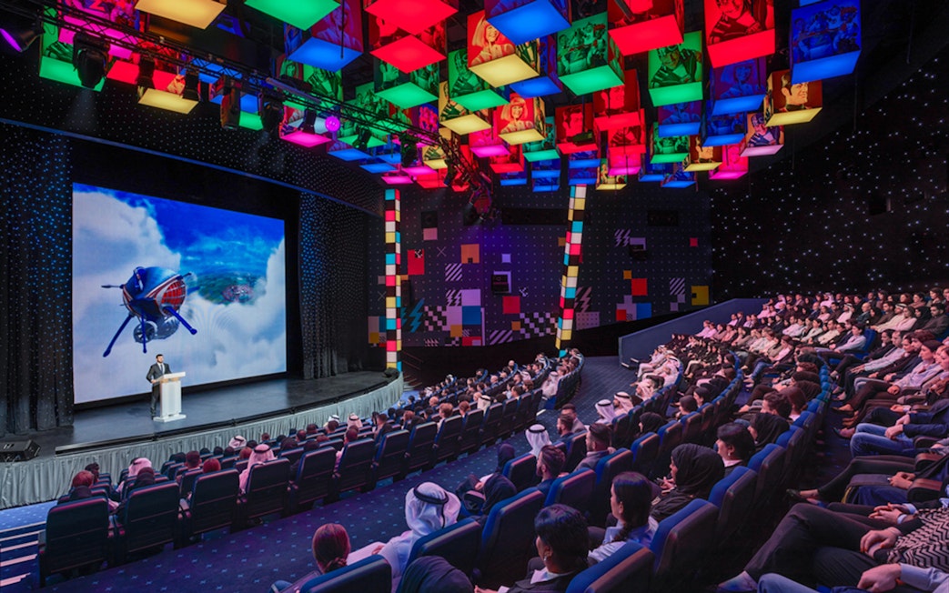 Audience watching a presentation at IMG Worlds of Adventure theater.