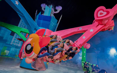 Riders enjoying a colorful spinning ride at IMG Worlds of Adventure.