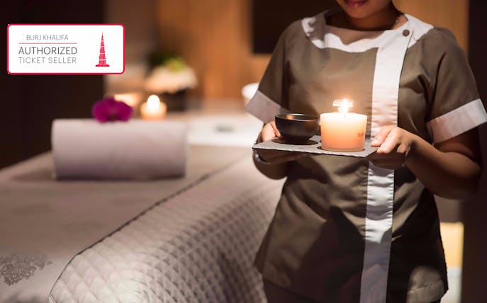 Spa treatment setup with candle and towel at The Burj Club, Dubai.