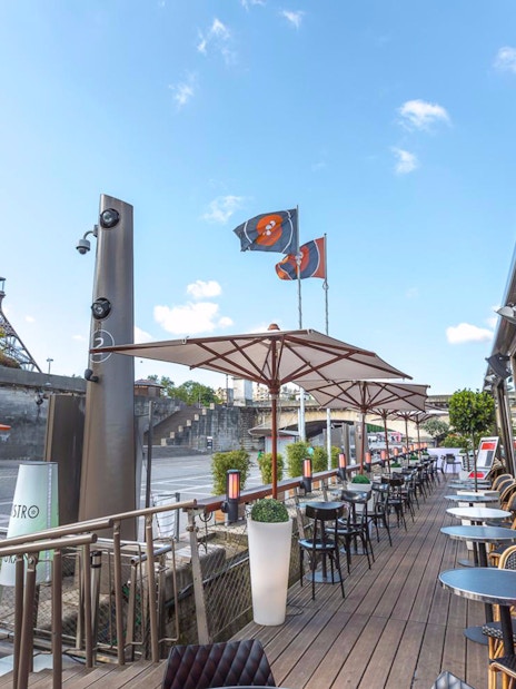 Le Bistro Parisien terrace with Eiffel Tower view, Paris, France.