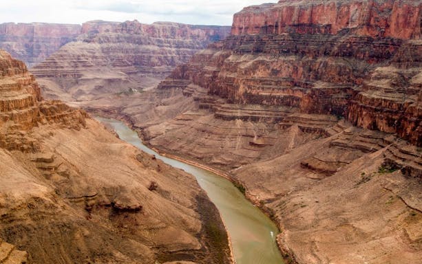 Grand Canyon aerial view with river, part of helicopter tour landing and picnic experience.