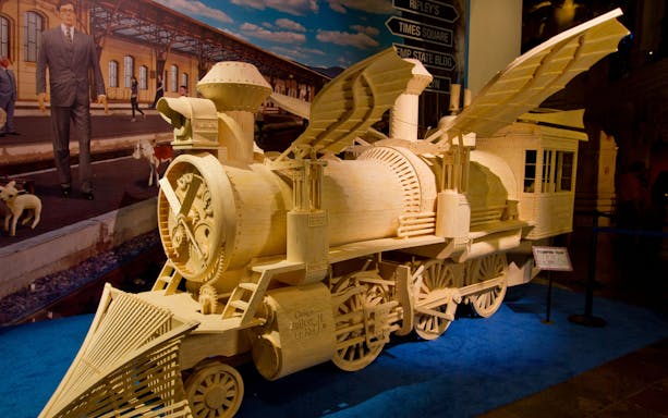 Wooden steam train model at Ripley's Believe It or Not, featuring intricate gears and wings.