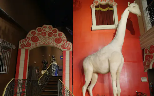 Ripley's Believe It or Not exhibit featuring a large white giraffe statue and ornate red archway.