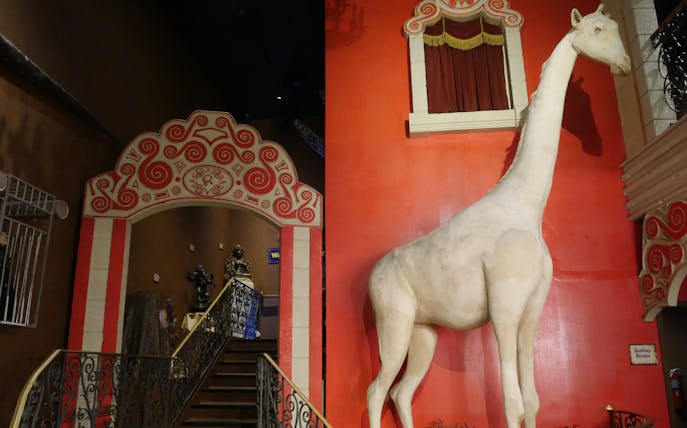Ripley's Believe It or Not exhibit featuring a large white giraffe statue and ornate red archway.