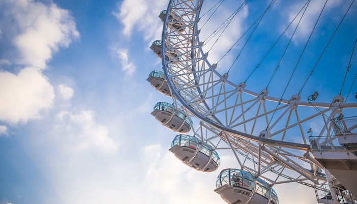 London Eye observation wheel against a blue sky.