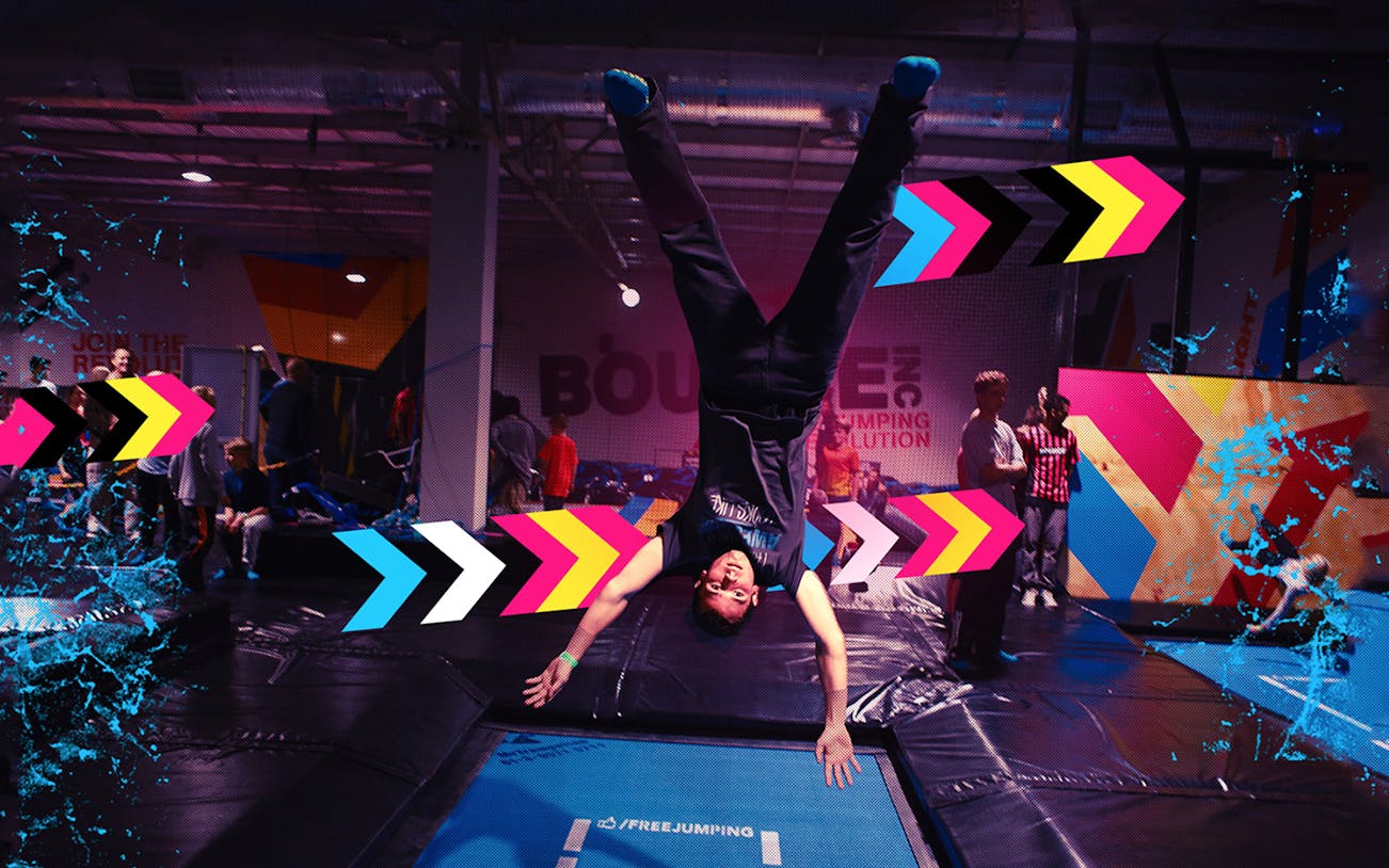 Person doing a handstand on a trampoline at Bounce Dubai indoor park.