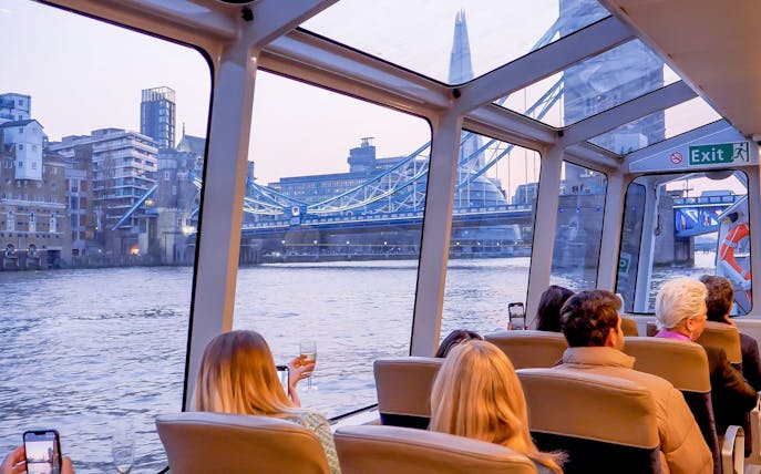 Cruise passengers view Tower Bridge and The Shard on the Thames in London.