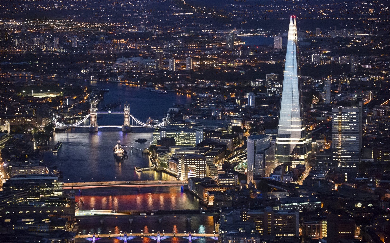 Aerial view of the Shard and Tower Bridge at night, London, for Thames Cruise and Shard tour.