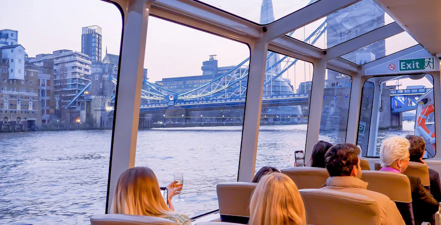 Cruise passengers view Tower Bridge and The Shard on Thames River, London.