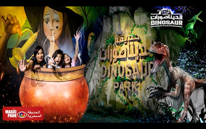 Visitors at Magic Park Dubai in a cauldron with Dinosaur Park sign.