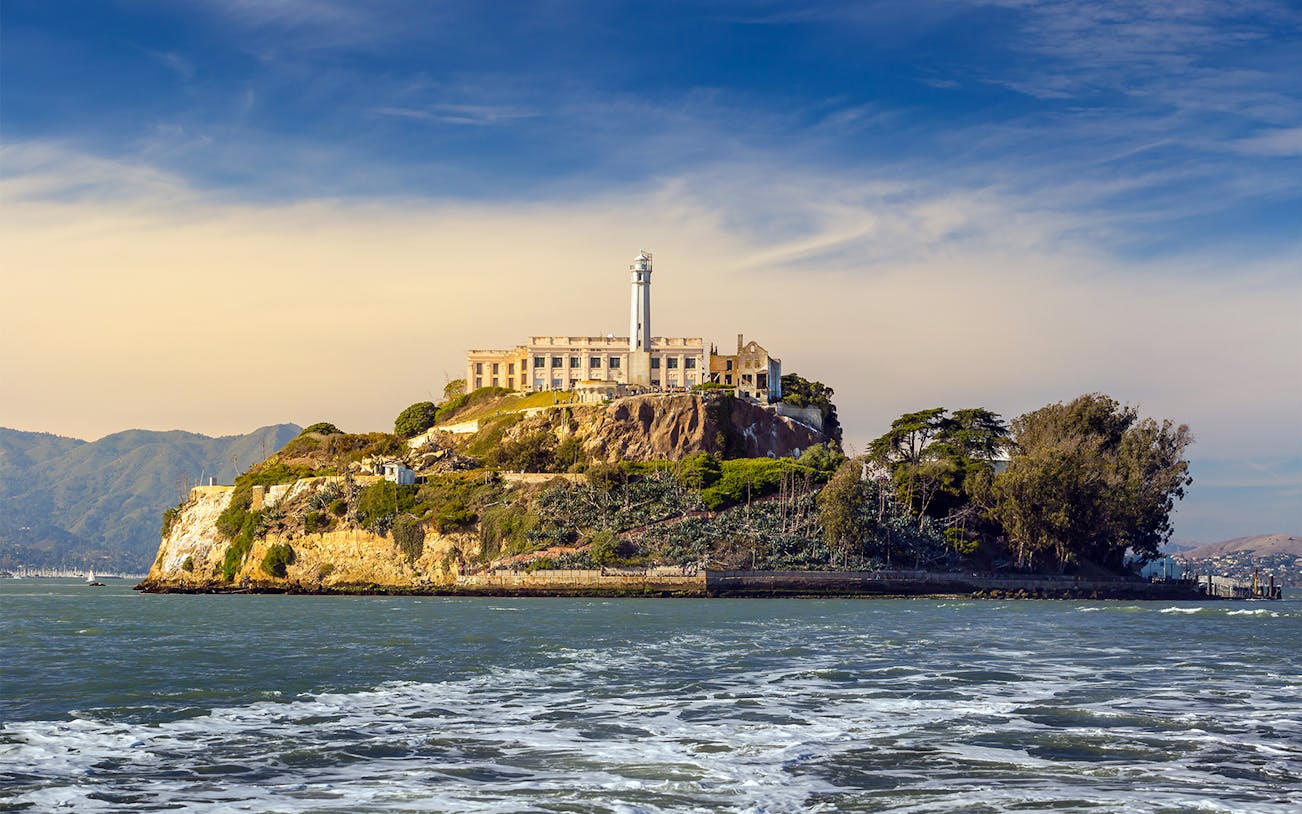 Group of tourists enjoying the San Francisco City Tour with an audio tour of Alcatraz, featuring iconic landmarks and stunning city views