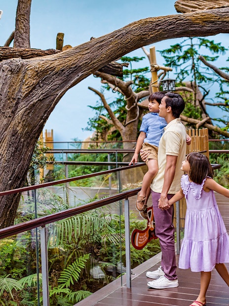 Family observing a red panda at River Wonders exhibit.