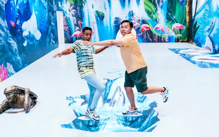 Visitors interacting with 3D art at Singapore Trick Eye Museum.