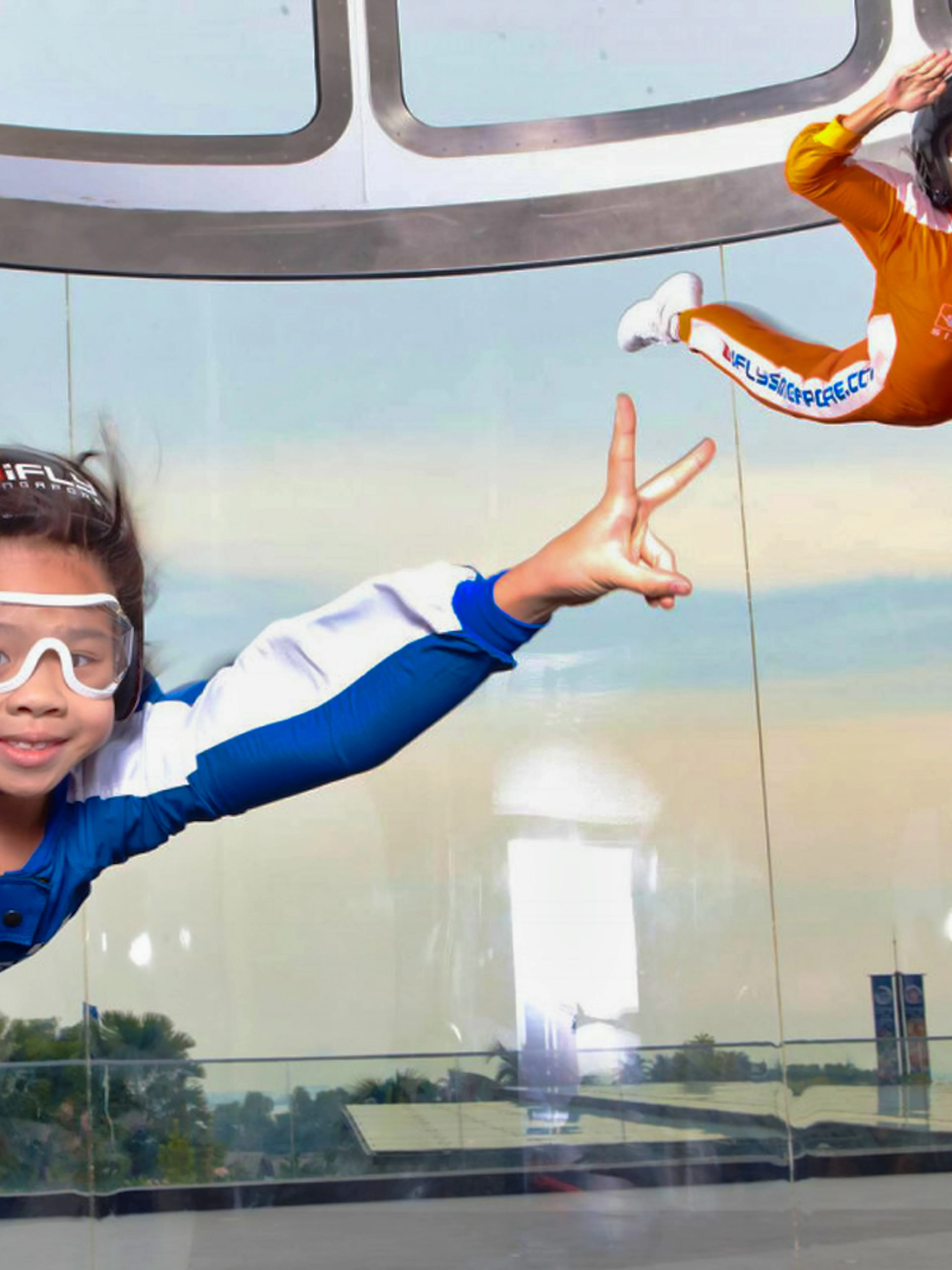 Participants enjoying indoor skydiving at iFly Singapore in a vertical wind tunnel.