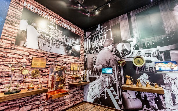 Heritage Corner at Tiger Brewery Tour showcasing vintage brewing equipment and historical photos.