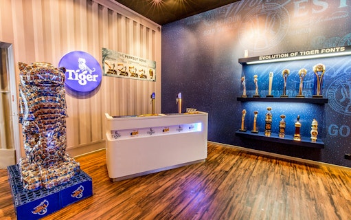 Tiger Brewery tour display with beer tap, awards, and branded decor.