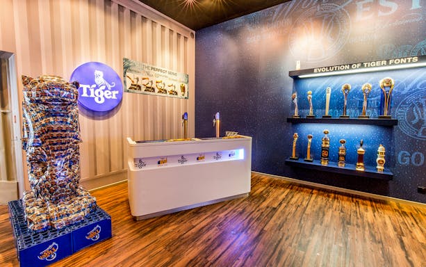 Tiger Brewery tour display with beer tap, awards, and branded decor.