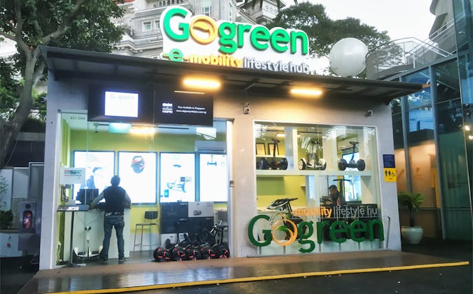 Go Green bicycle rental shopfront in Sentosa, showcasing e-mobility options.