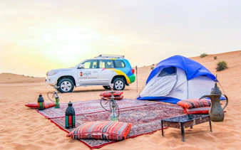 Desert campsite with tent, 4x4 vehicle, and traditional setup for Morning Desert Safari.