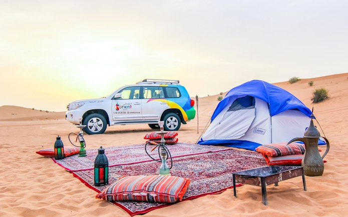 Desert campsite with tent, 4x4 vehicle, and traditional setup for Morning Desert Safari.