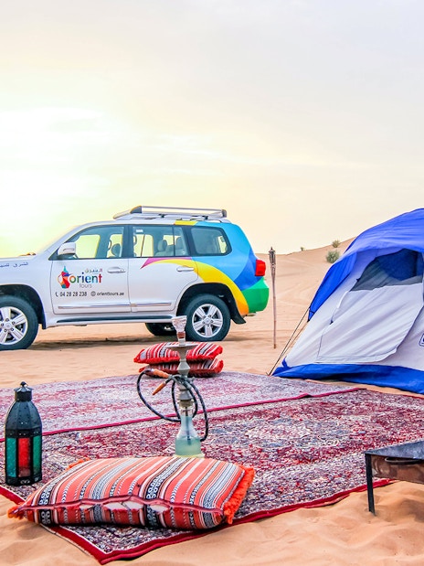 Desert campsite with tent, 4x4 vehicle, and traditional setup for Morning Desert Safari.