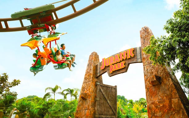 Visitors on a ride near Jurassic Park entrance at Universal Studios Singapore.