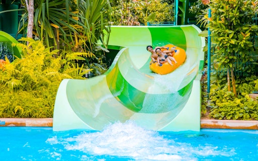 Visitors enjoying a water slide at Adventure Cove Waterpark, Universal Studios Singapore.