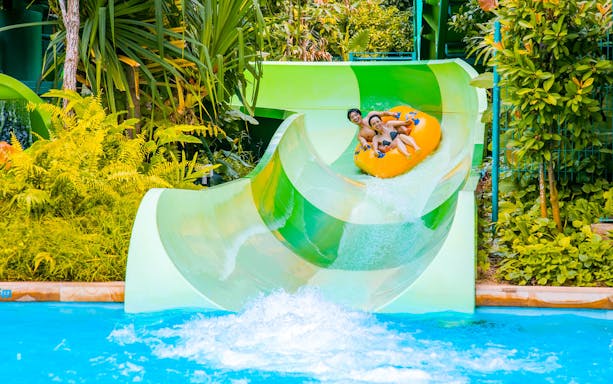 Visitors enjoying a water slide at Adventure Cove Waterpark, Universal Studios Singapore.