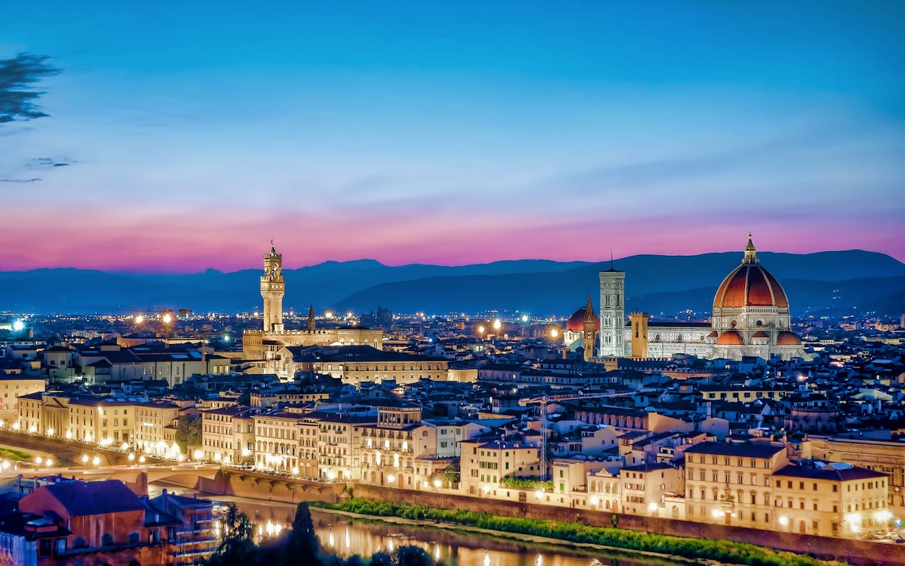Florence skyline at sunrise with the Duomo and Palazzo Vecchio.