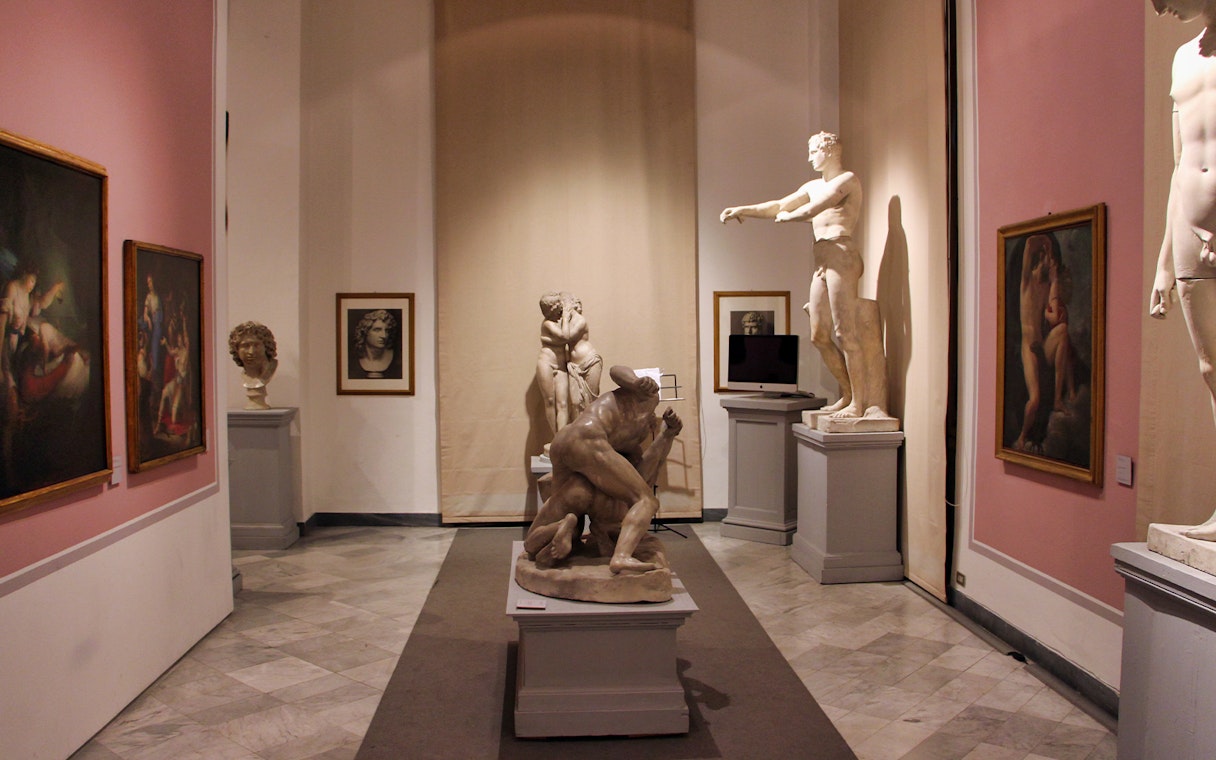 Sculptures and paintings in a gallery room at Uffizi Gallery, Florence.