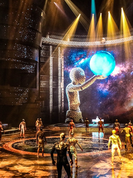 Performers on stage at La Perle by Dragone, Dubai, with a cosmic backdrop.