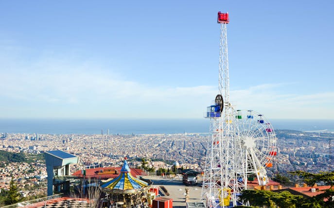 Ferris wheel and carousel at Tibidabo Amusement Park overlooking Barcelona.