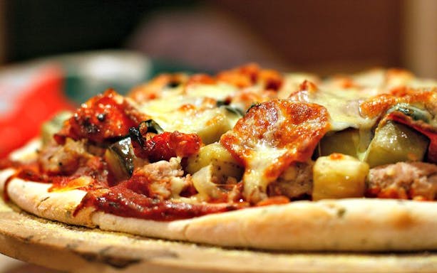 Pizza with toppings on North Beach Food Tour in San Francisco.