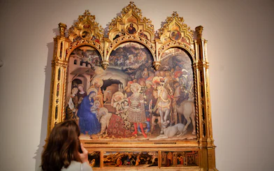 Visitor admiring a Renaissance painting at the Uffizi Gallery in Florence.