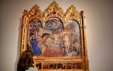 Visitor admiring a Renaissance painting at the Uffizi Gallery in Florence.