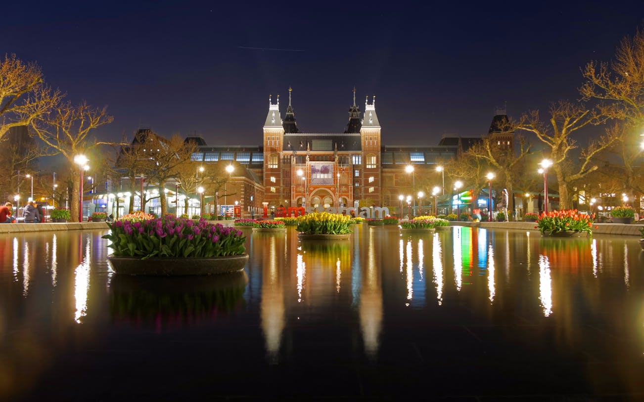 Rijksmuseum at night with tulip reflections in Amsterdam.