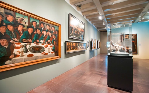 Amsterdam museum gallery with historical paintings and sculptures.
