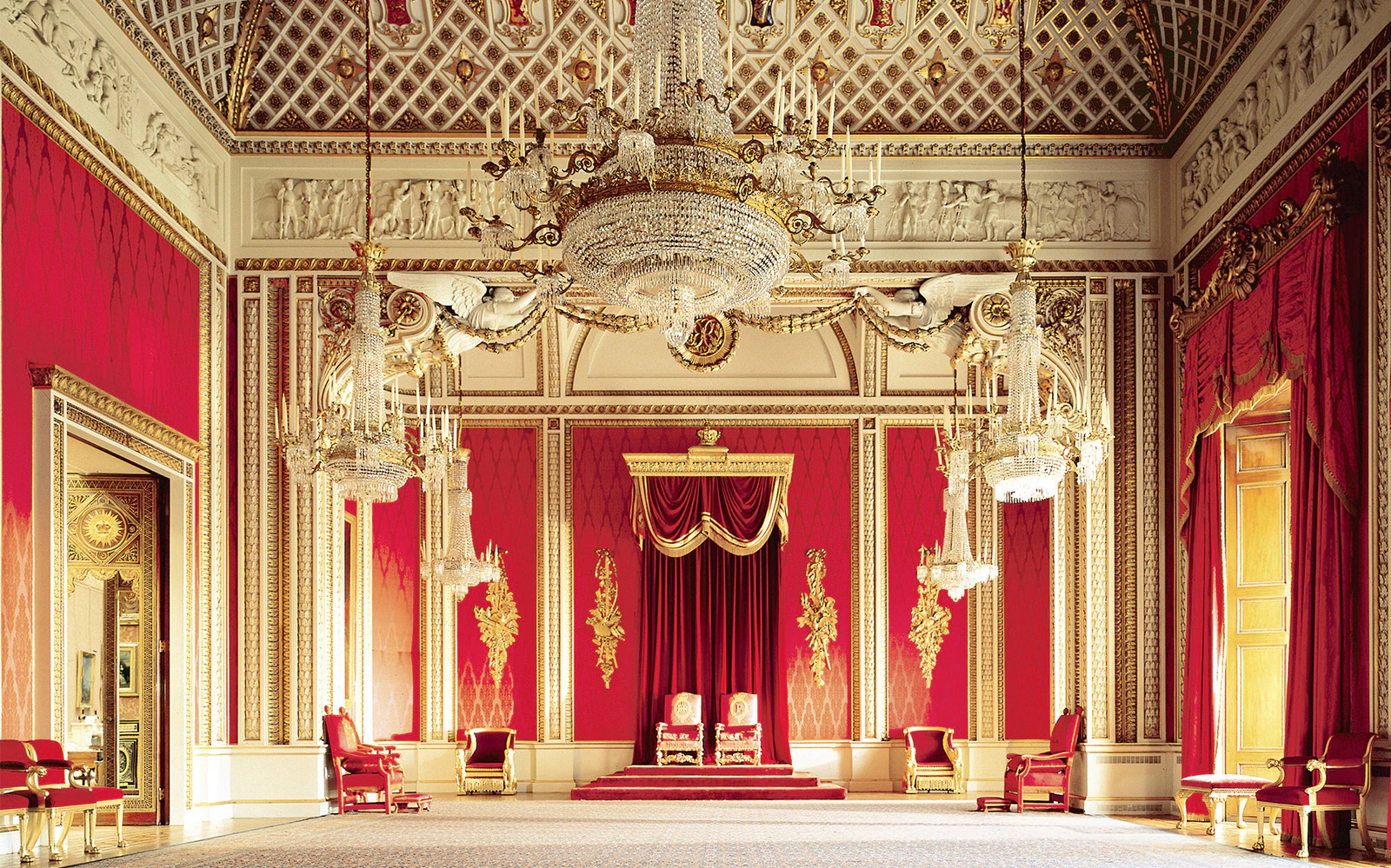 Buckingham Palace State Rooms with ornate chandeliers and red decor.