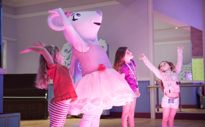 Children dancing with a costumed character at Mattel Play! Town.