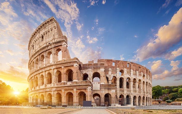 Colosseum in Rome at sunset, part of Combo: Leonardo Express One-Way Tickets + 48-Hr Rome Pass.