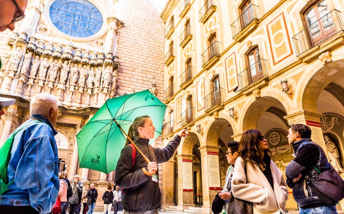 Tour group with guide at Montserrat Monastery, Spain, during self-guided tour.