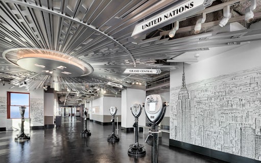 Empire State Building Observatory interior with viewing scopes and city mural.