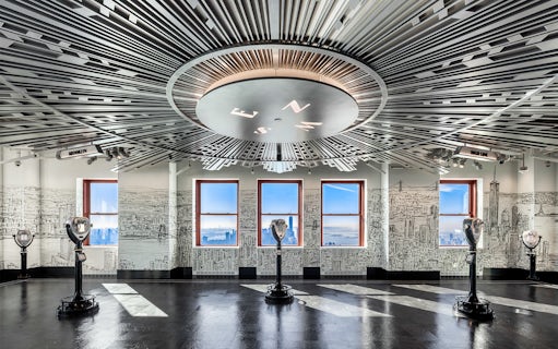 Empire State Building Observatory interior with city views through windows.